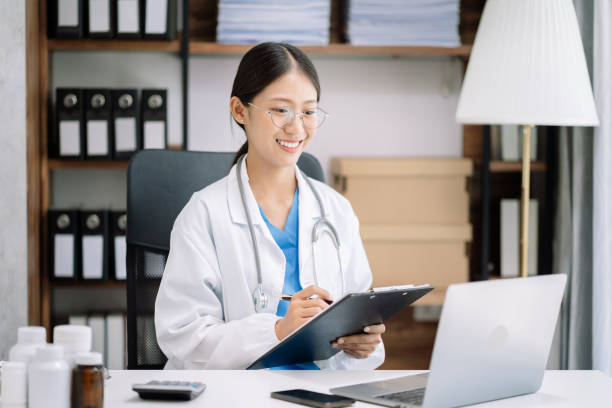female medicine doctor hand holding silver pen writing something on clipboard close up. ward round, patient visit check, medical calculation and statistics concept. - doctor electronic organizer healthcare and medicine patient imagens e fotografias de stock