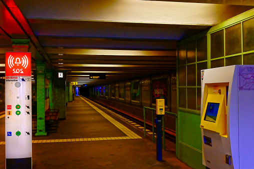 Berlin, Germany - February 27, 2020: View into a station of the Berlin subway. On the left you can see an SOS telephone, on the right there is a ticket machine.