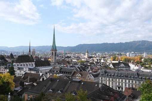 A breathtaking view of Zurich buildings and the surrounding countryside with blue cloudy sky