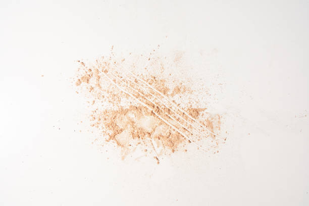 istock A neutral-colored face powder applied to a surface on a light background. Top view, flat position. With space to copy. Powder texture. High quality photo 1499440570