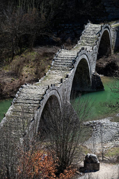 Old bridge in Zagori, Greece View of the traditional stone Kalogeriko or Plakida Bridge in Zagori of Epirus, Greece in Autumn zagori stock pictures, royalty-free photos & images