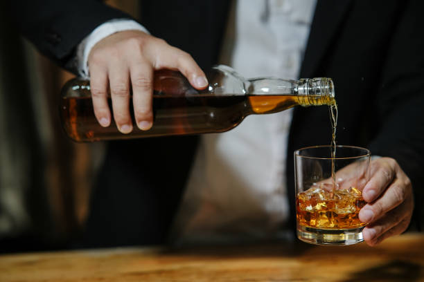 whiskey Barman pouring whiskey whiskey glass beautiful night liquor store counter photos stock pictures, royalty-free photos & images