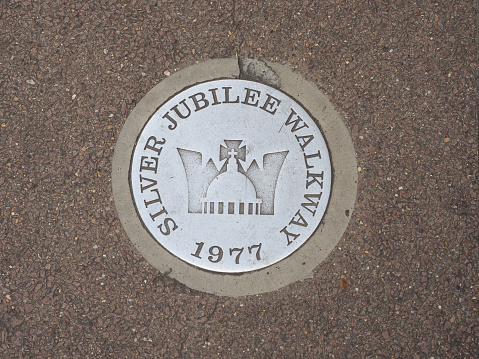 A close view of the silver metal mile marker.