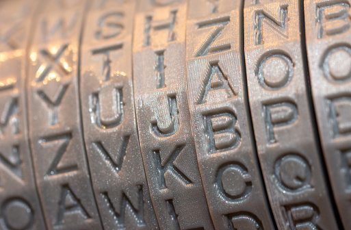 Close-up of plastic parts printed on a 3D printer, round letters rings for cryptex