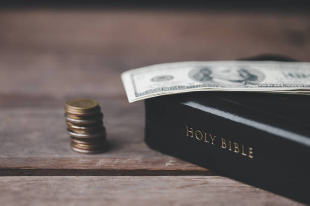 istock One tenth or tithe is basis on which Bible teaches us to donate one tenth of first fruit to God. Coins with Holy Bible. Religion donation and funding. Giving money, the symbol of Christianity donation 1499467030