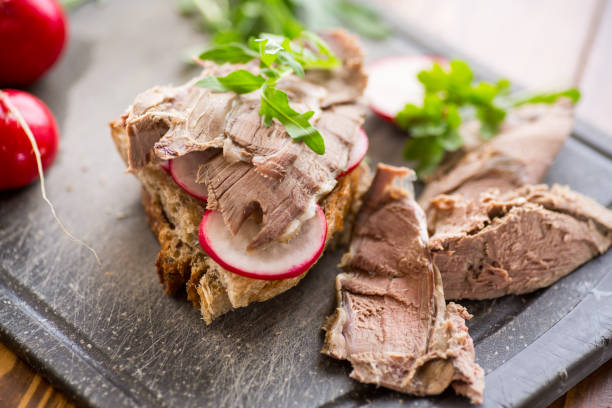 sandwich with baked meat, radish and herbs stock photo