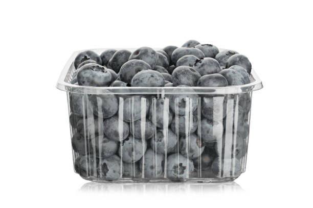 Fresh blueberries in a plastic container, isolated on a white background.