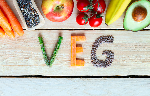 Colorful fruits, vegetables,  on wood background with word veg