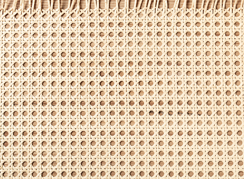 Embossed background of large-weave rattan stems.