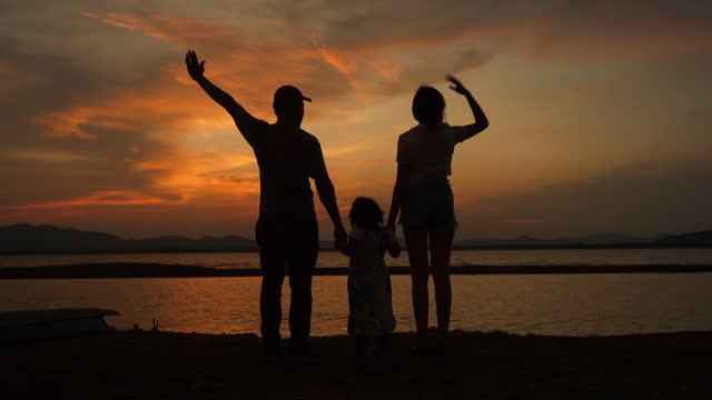 Family walking at sunset.