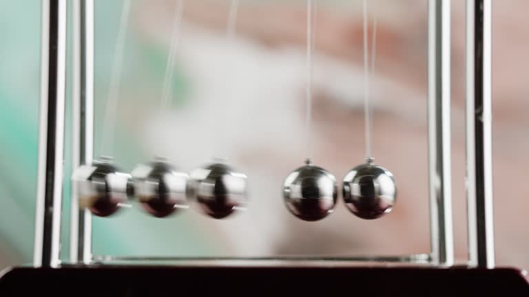 Newton balls close-up, five metallic pendulums colliding, cradle. Physics and science concept.