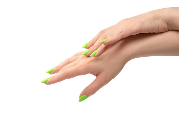 istock Hand of a woman with green naols hold some tiny or thin object. 1499479451