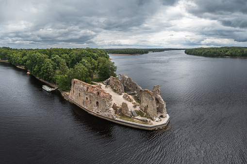 Beautiful aerial view of Olavinlinna, Olofsborg ancient fortress, the 15th-century medieval three - tower castle located in Savonlinna city on a sunny summer day, Finland. Shooting from a quadcopter