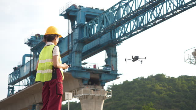 Asian woman engineer operate flying drone.