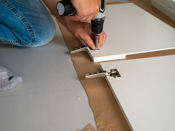 istock A man assembles furniture at home with a professional screwdriver. 1499483108