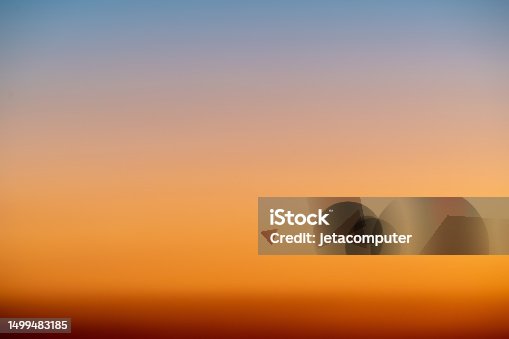 istock The dramatic colors of the sunset in the sky gradient from blue to orange. 1499483185