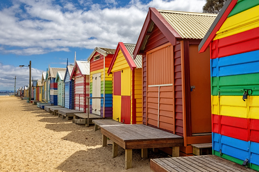 Brighton beach Victorain bathing boxes. Brightly painted colourful beach huts line the sand in Melbourne, Australia. They are highly desirable and extremely expensive real estate.
