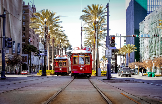 A red trolley on Canal Street in downtown New Orleans, Louisiana