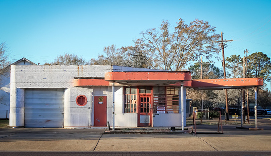 A red and white mechanic shop in the early morning sunlight in Alexandria, Louisiana