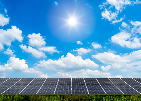 photovoltaic solar power panel on dramatic sunset blue sky background, green clean Alternative power energy concept.