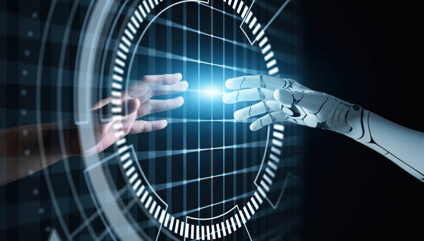 Hands of Robot and Human Touching together through computer monitor screen in dark background. Virtual Reality Augmented reality Artificial Intelligence technology digital twin driven smart concept stock photo
