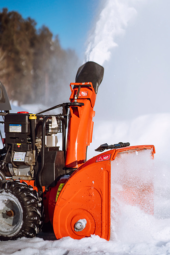 Snow-removal work with a snow blower. Clearing service the area from snowfall. Snow clearing services.