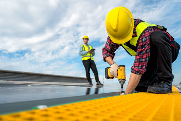istock Technicians are installing solar panels on factory roof, with Asian engineer supervising, supervising installation. Installation of solar panels to transform solar energy into sustainable electricity. 1499492302