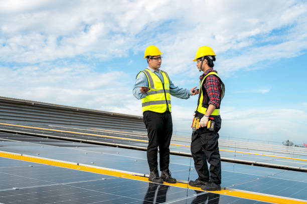 istock Technicians are installing solar panels on factory roof, with Asian engineer supervising, supervising installation. Installation of solar panels to transform solar energy into sustainable electricity. 1499492312