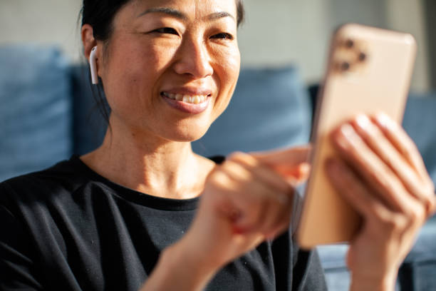 istock Young Japanese woman using a smart phone after exercising at home 1499493853
