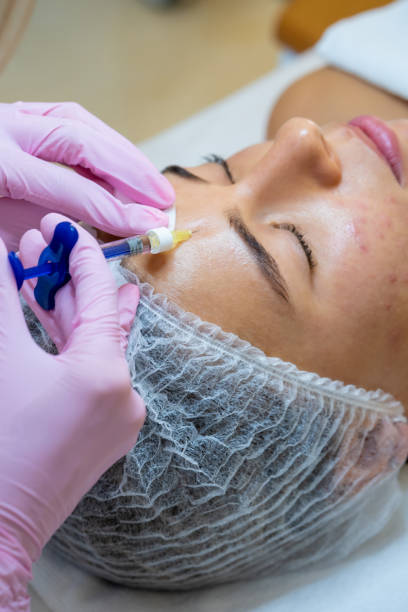 istock Cosmetologist doing PRP ttherapy in beauty clinic, making injection. 1499495155
