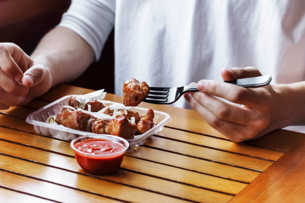 istock person eats food packed in disposable dishes 1499495410