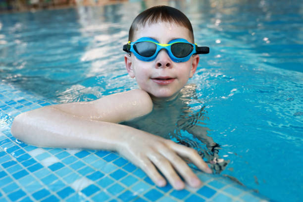 istock Boy resting holding on to side of pool 1499495495
