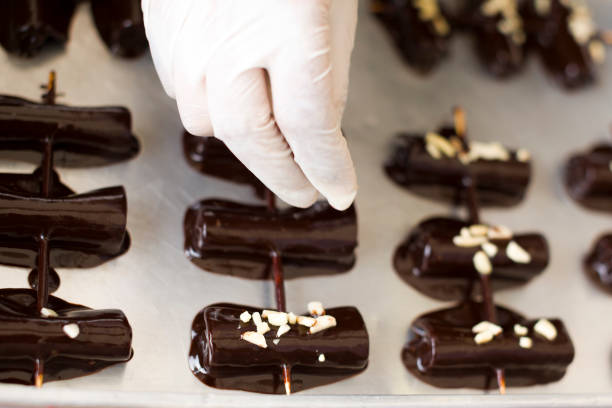 istock Decorating Small dried rolled thai bananas in chocolate coating on tray 1499495983