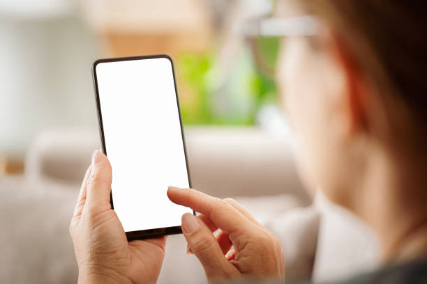 istock Close up of woman's hands using smartphone at home 1499499415