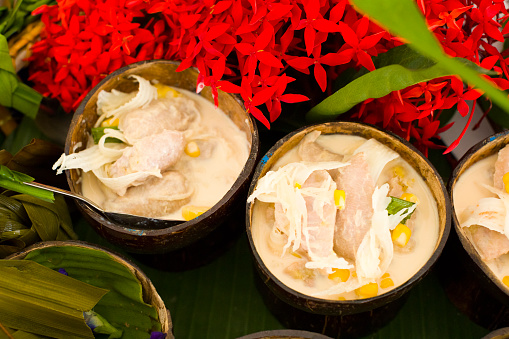 Thai banana coconut dessert in cross sections of coconut shells