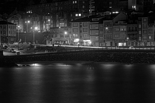 Fishing village of A Guarda (La Guardia), in Galicia, Spain. Close-up view of seaside village near portuguese border ,row of houses. Long exposure black and white view of waterfront promenade..