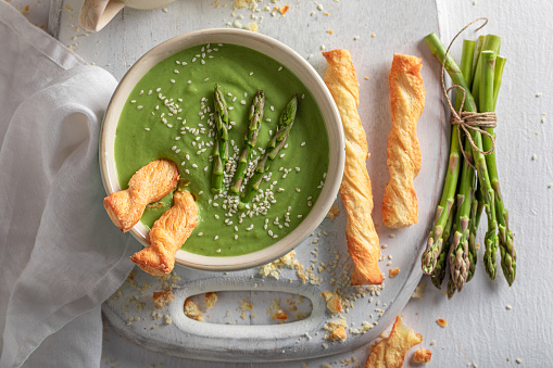 Healthy and fresh creamy asparagus soup as healthy diet. Veggie soup made of vegetables.
