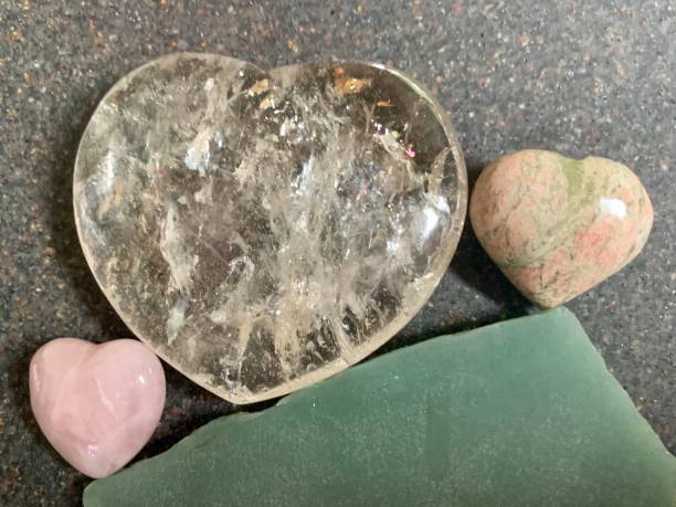 istock Three crystal hearts balance on aventurine slab 1499513310