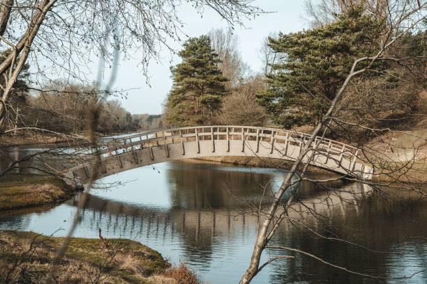 istock Scenic autumn landscape featuring a bridge stretching across a river 1499514367