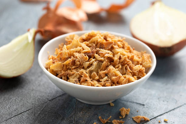 istock Crispy Fried onions flakes in white bowl. 1499514931