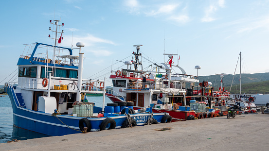 Gökçeada, Çanakkale, Turkey May 27, 2023 Kalekoy Harbor with moored swordfish ships. Kalekoy is the oldest port of Gokceada.