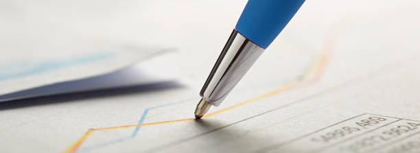 istock Checking the value of securities. Pen, share listing and checking financial chart. Concept of banking, financial report and financial audit. 1499520373