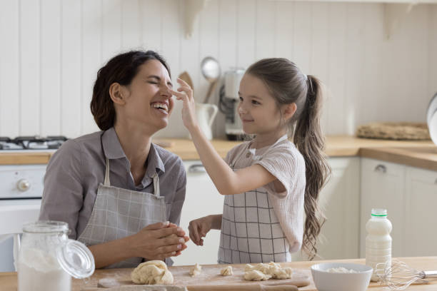 istock Happy mother and kid in aprons baking in home kitchen 1499522860