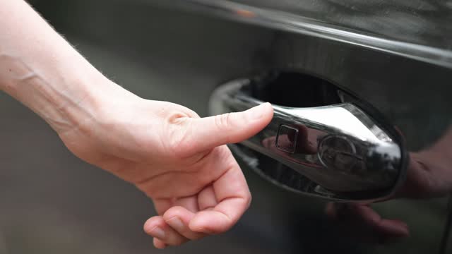 Car owner presses button trying to open modern vehicle