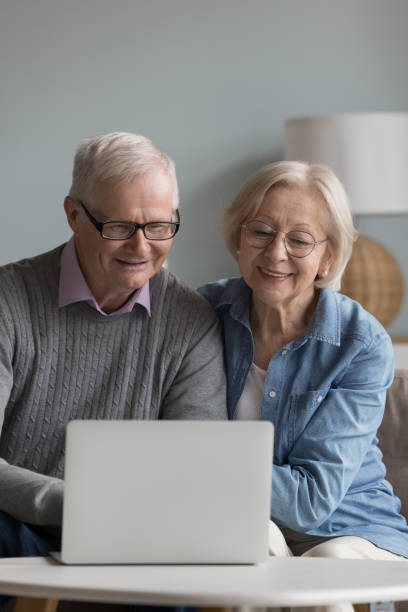 istock Happy elderly husband and wife in glasses using online app 1499524903