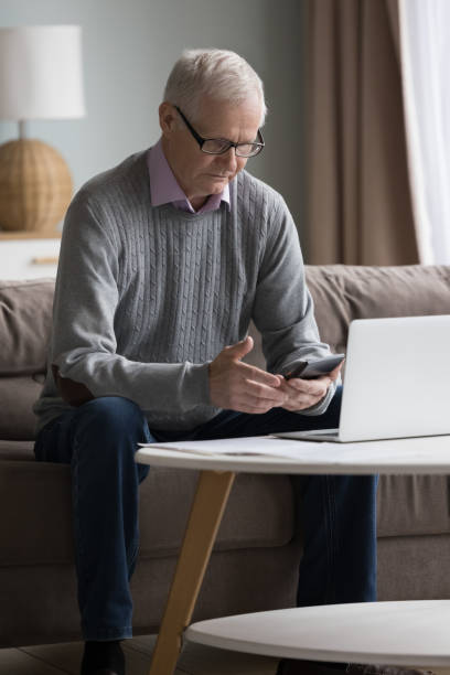 istock Concerned puzzled senior laptop user man calculating expenses 1499524904