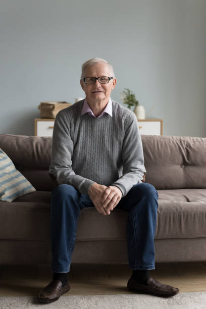istock Old senior retired man in glasses sitting on sofa 1499524920