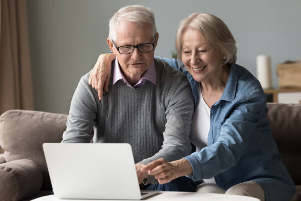 istock Happy joyful elderly senior couple using online application 1499524972