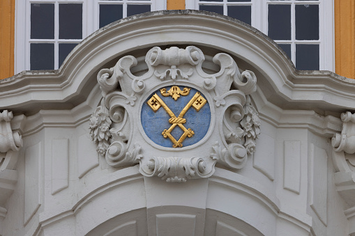 Melk, Austria - February 24, 2023: Melk Abbey on hill above town, decorative portal with Melk Abbey coat of arms. It was was founded in 11th century, today's baroque abbey was built in 18th century