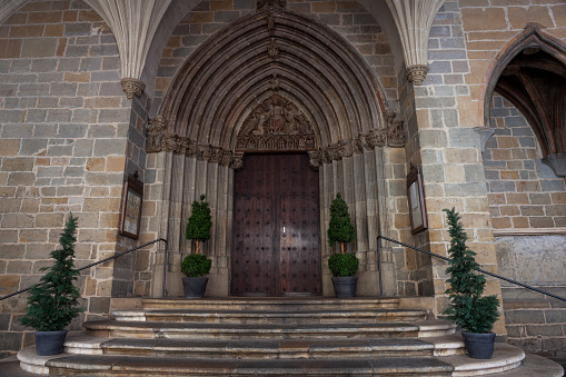 Perspective of the Gothic portico of the Church of Sain Saturnin, in Spanish iglesia de San Saturnino, in Pamplona, Navarre, Spain. Represents Christ the Judge, the Trinity and Calvary